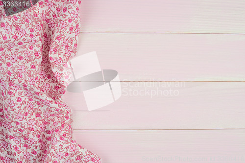 Image of Pink towel over wooden table