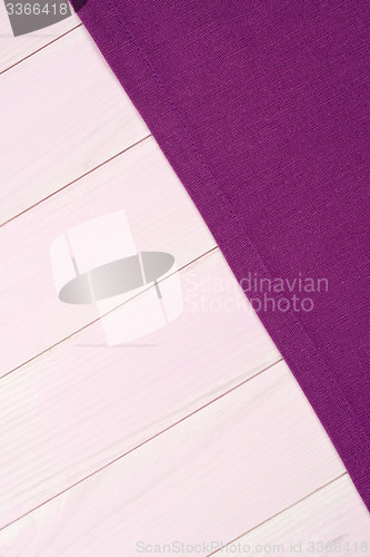 Image of Purple towel over wooden table