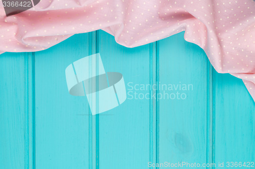 Image of Pink towel over wooden table