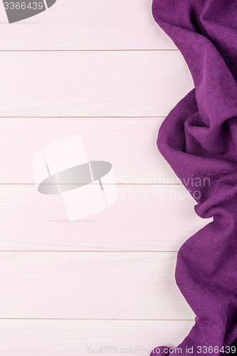 Image of Purple towel over wooden table