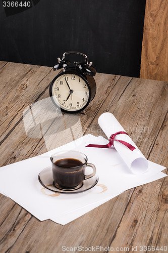 Image of Old clock, hat, coffee and paper sheets