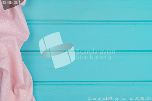Image of Pink towel over wooden table