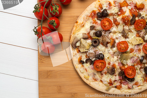 Image of Pizza with bacon, olives and tomato