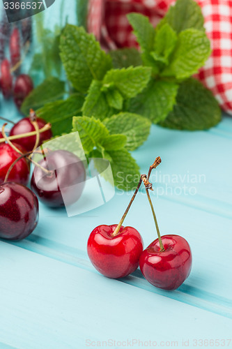 Image of Cherries in blue wooden table
