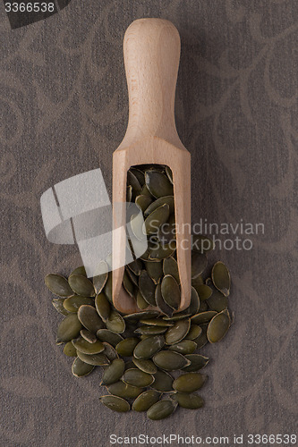 Image of Wooden scoop with pumpkin seeds