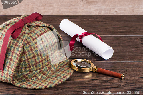 Image of Wrapped paper sheets and magnifying glass