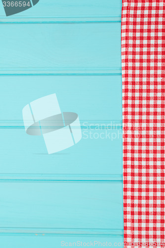 Image of White and red towel over wooden table