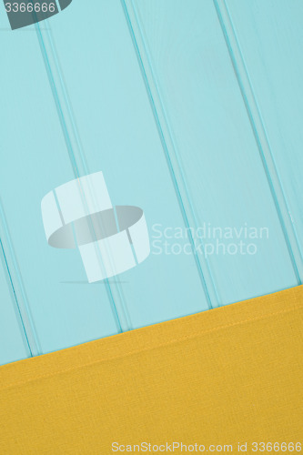 Image of Green towel over wooden table