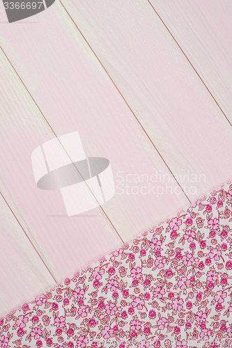 Image of Pink towel over wooden table
