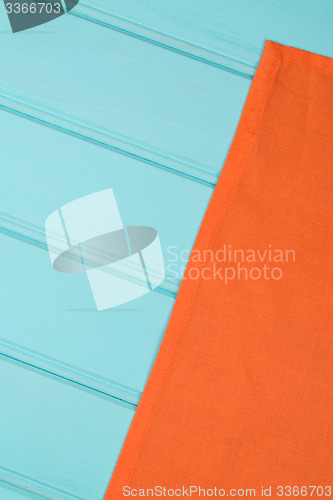 Image of Orange towel over wooden table