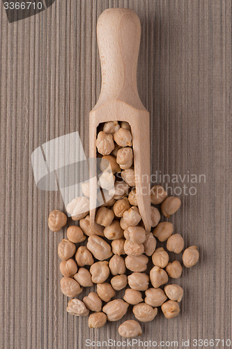 Image of Wooden scoop with chickpeas