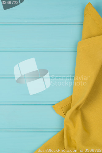 Image of Green towel over wooden table