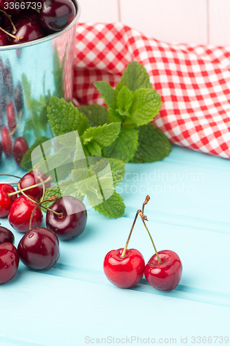 Image of Cherries in blue wooden table