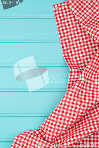 Image of White and red towel over wooden table