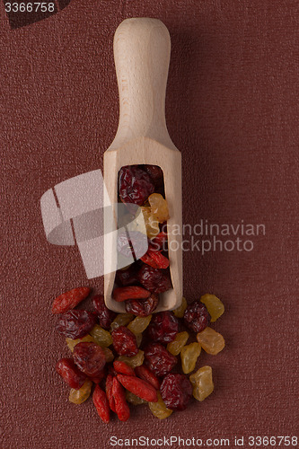 Image of Wooden scoop with mixed dried fruits