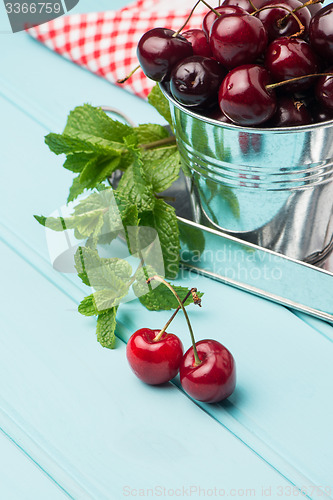 Image of Cherries in blue wooden table