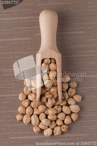 Image of Wooden scoop with chickpeas