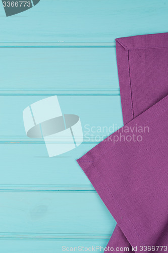 Image of Purple towel over wooden table