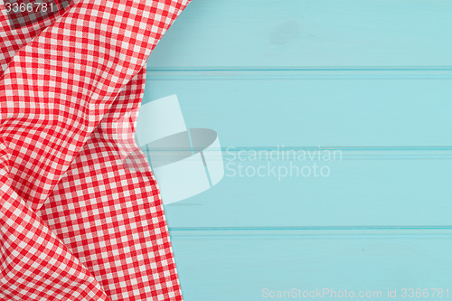Image of White and red towel over wooden table