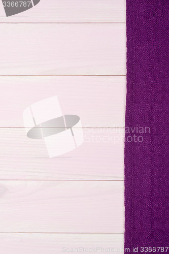 Image of Purple towel over wooden table