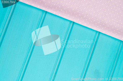 Image of Pink towel over wooden table