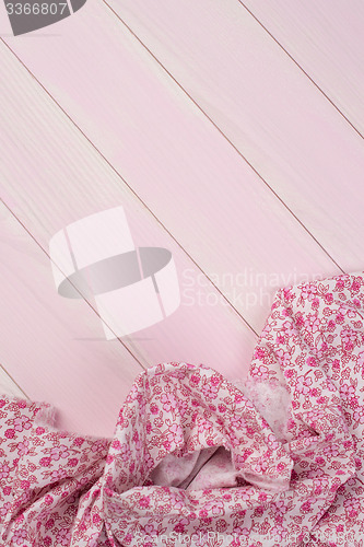 Image of Pink towel over wooden table