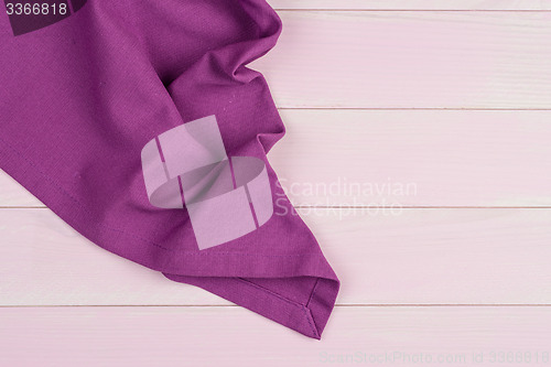 Image of Purple towel over wooden table