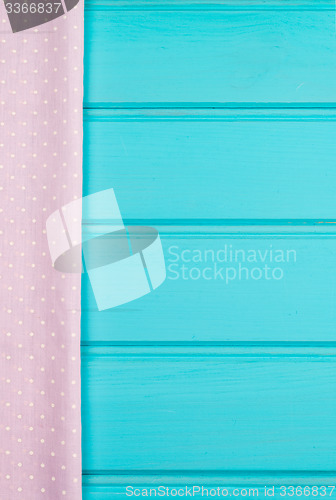 Image of Pink towel over wooden table