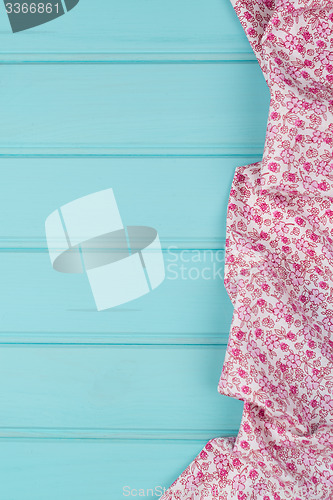 Image of Pink towel over wooden table