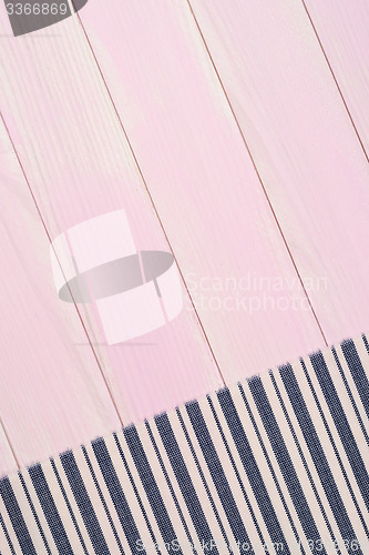 Image of White and blue towel over wooden table