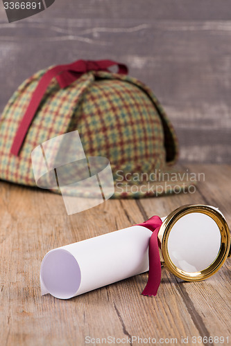 Image of Wrapped paper sheets and magnifying glass