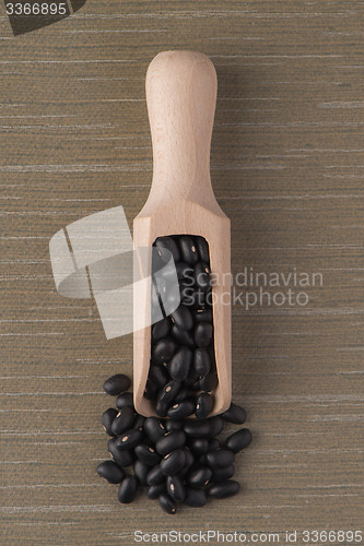 Image of Wooden scoop with black beans