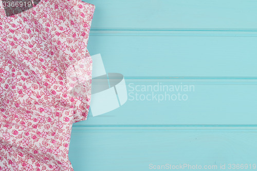 Image of Pink towel over wooden table
