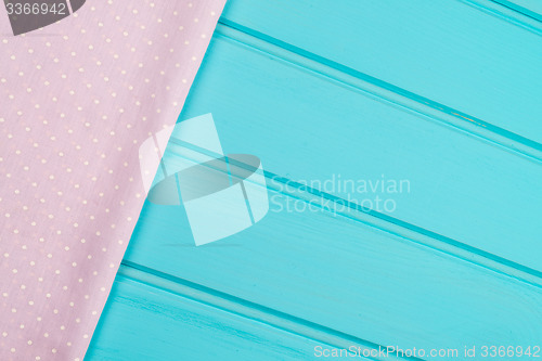 Image of Pink towel over wooden table