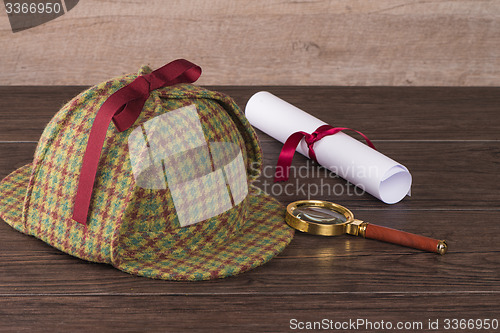 Image of Wrapped paper sheets and magnifying glass