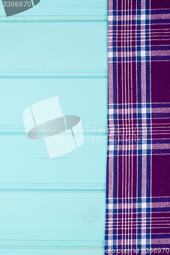 Image of Purple towel over wooden table