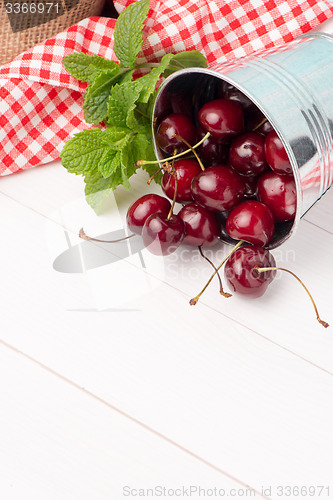 Image of Cherries in small metal bucket