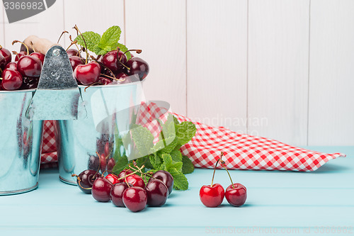 Image of Cherries in two small metal buckets