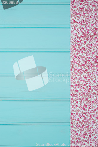 Image of Pink towel over wooden table