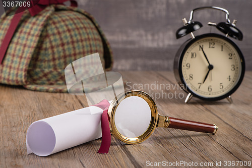 Image of Wrapped paper sheets and magnifying glass