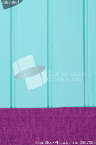 Image of Purple towel over wooden table
