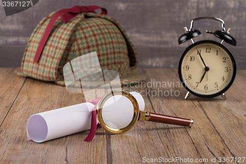 Image of Wrapped paper sheets and magnifying glass