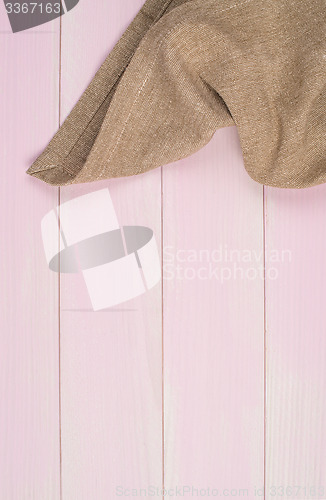 Image of Beige towel over wooden table