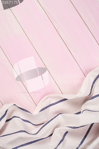 Image of White and blue towel over wooden table