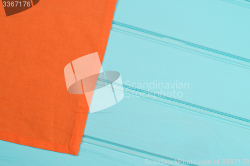 Image of Orange towel over wooden table