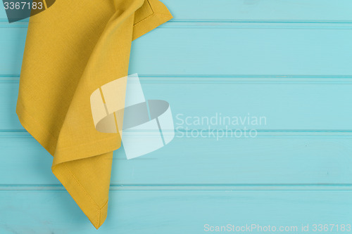 Image of Green towel over wooden table