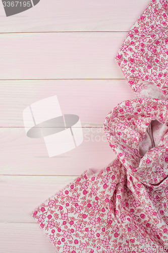 Image of Pink towel over wooden table