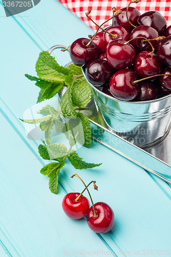 Image of Cherries in blue wooden table