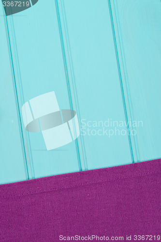 Image of Purple towel over wooden table