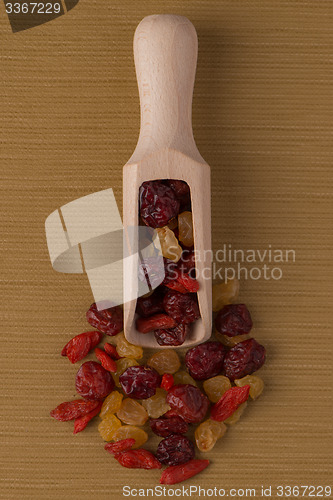 Image of Wooden scoop with mixed dried fruits